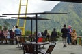 visitors to a cafe are resting and enjoying the view of the green hills in the Sembalun area of Ã¢â¬â¹Ã¢â¬â¹the Mount Rinjani